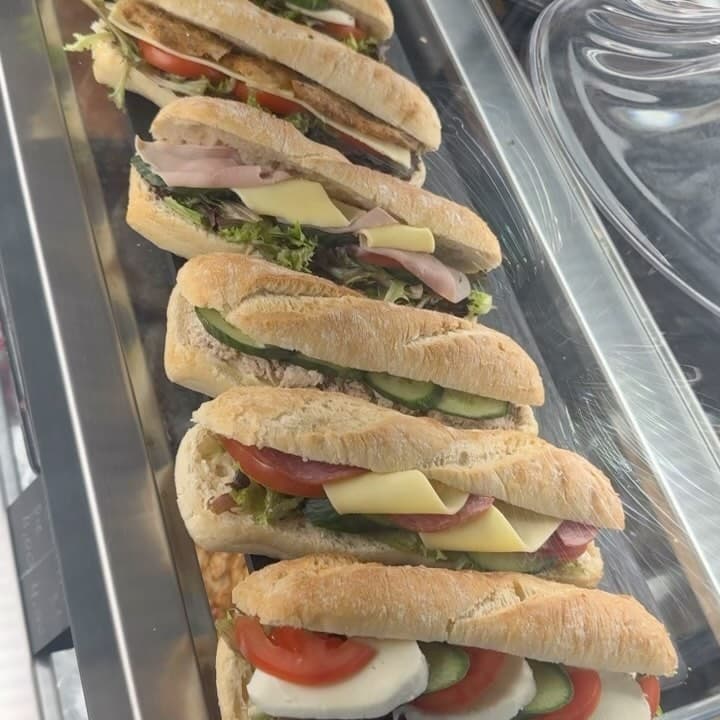 The deli case at Phyllo & Filo — a row of ciabatta and baguette sandwiches